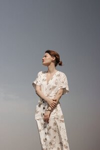 woman in floral dress standing in the sun