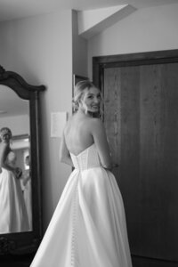 black and white photo of bride getting ready