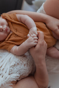Lifestyle photographer capturing family session in Missouri photography studio
