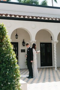 Bride and groom at wedding venue back to back reading notes taken by east coast photographer