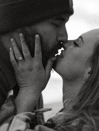 black and white photo of couple kissing