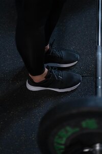 Female trainer deadlifting