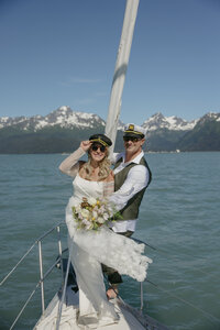 A couple on a sailboat while wearing fun hats in Seward, Alaska. 