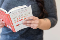 Holding the book Building a Story Brand