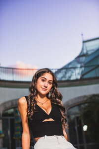 Elegant evening senior pictures Pittsburgh pa architecture backdrop featuring young woman in formal attire. 