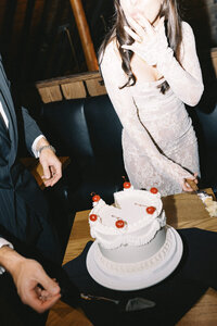 bride licking her fingers from cake