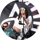 A person on stage singing into a mic 