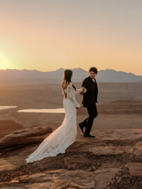 Bride and groom walking together in Moab elopement at sunrise