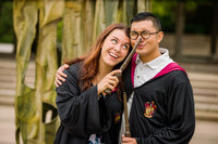 Harry Potter-inspired engagement session featuring a couple posing with wizarding props and playful vibes.
