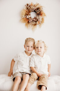 two little boys posing for a photo in family photographer michelle kellys studio
