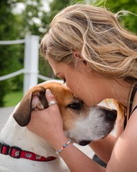 Woman Kissing Dog