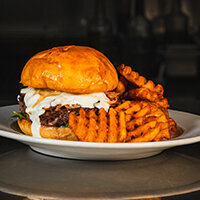 Blended Burger with crimini and prime beef blend, dijon ailoi, arugula, roma tomato, sauteed mushrooms, caramelized onions, bacon, mornay cheese sauce, and fries from  from Max Dales Steak and Chop House Mount Vernon Restaurant