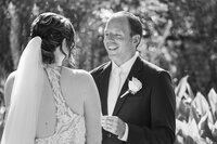 Groom holding his bride's ring on his hand before doing the ring exchange. Emotional moment captured by wedding photographer in Sarasota Popping Champaign Photography