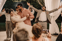 A person dipping their partner as they dance at their wedding reception 