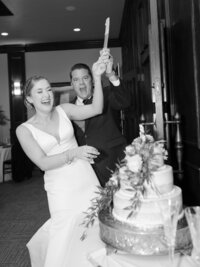 Bride and groom laugh at each other under the veil.