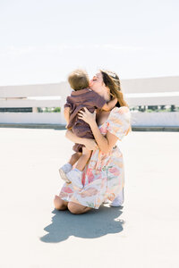 A mother snuggles her son close during their Downtown Fresno family photos