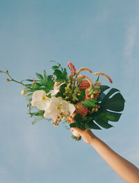 Film photograph of a colorful bouquet in the blue sky for a beach wedding in Tulum, Mexico. 
