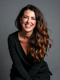 A headshot of Missy Mayo as she leans into the camera and confidently smiles.