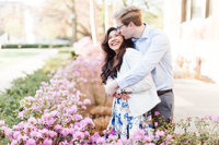 Engagement photo by Victoria Hunt Photography with pink flowers blooming