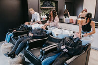 Clients enjoying a relaxing shampoo service at Salon Beau, a modern hair salon near Melrose and Cambridge.