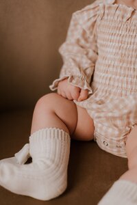 little girl poses for family portraits in peoria il