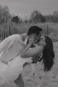 A couple kissing on the beach as they elope in Maryland