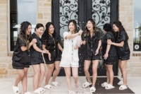 Bride and her bridesmaids spray champagne