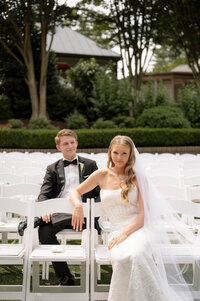 An engaged couple kisses in an art museum. Behind them are 6 paintings in European art style.