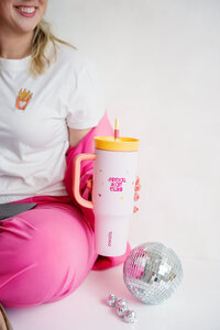 Kat Murphy in a pink Social Kat Media sweatshirt in front of a white wall