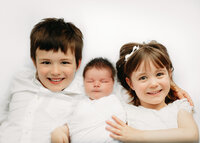 Image of new parents with their baby at a studio newborn photography session by Hobart Newborn Photographer, Lauren Vanier