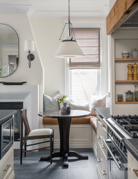 timeless bright white kitchen with marble counters striped roman shade and gold pendant lights