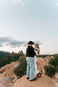 Chic and intimate wedding moment at Hotel Herringbone in Waco, featuring a bride and groom in love, cozying up in a moody, editorial-style setting.
