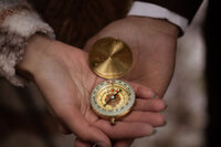 Bride and groom holding a compass during their Utah elopement, symbolizing adventure, captured by Lamblight Photography