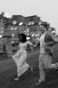 couple running down hill with motion blurr