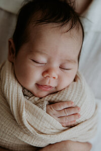 close up of newborn baby smiling