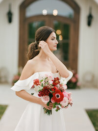 elegant bride with red bouquet