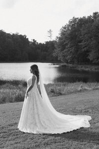 Documentary wedding photographer captures bride in dreamy ivory wedding dress as she approaches groom for first look in west Alabama wedding