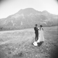 couple standing in a field saying their vows