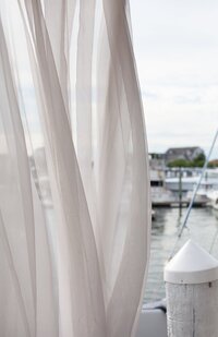 Sheer drapes blow in wind during. Newport Wedding Ceremony Deborah Zoe.