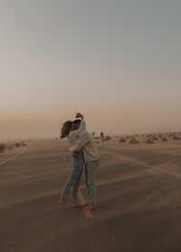 couple embracing in the dunes