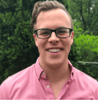 Man in pink shirt smiling