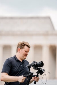 Storyteller team member Kevin Christensen holds a camera.