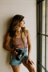 A camera setup with a soft portrait shot in the background, representing step-by-step photography tutorials for beginners and professionals.