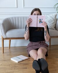 Female entrepreneur warmly inviting new clients to read more about her website design business.