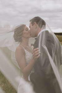 bride and groom in front of glacier