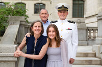 Naval Academy Family poses and smiles for a photo by Kelly Eskelsen during commissioning week in Annapolis, Md.