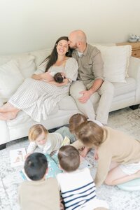 Mom and dad playing with children during Nashville newborn session
