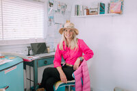 courtney brown at her desk in pink shirt