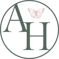 Green circular outline with AH within and blush pink small butterfly above the H