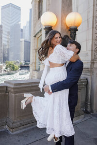 A couple being swung around and laughing with each other 